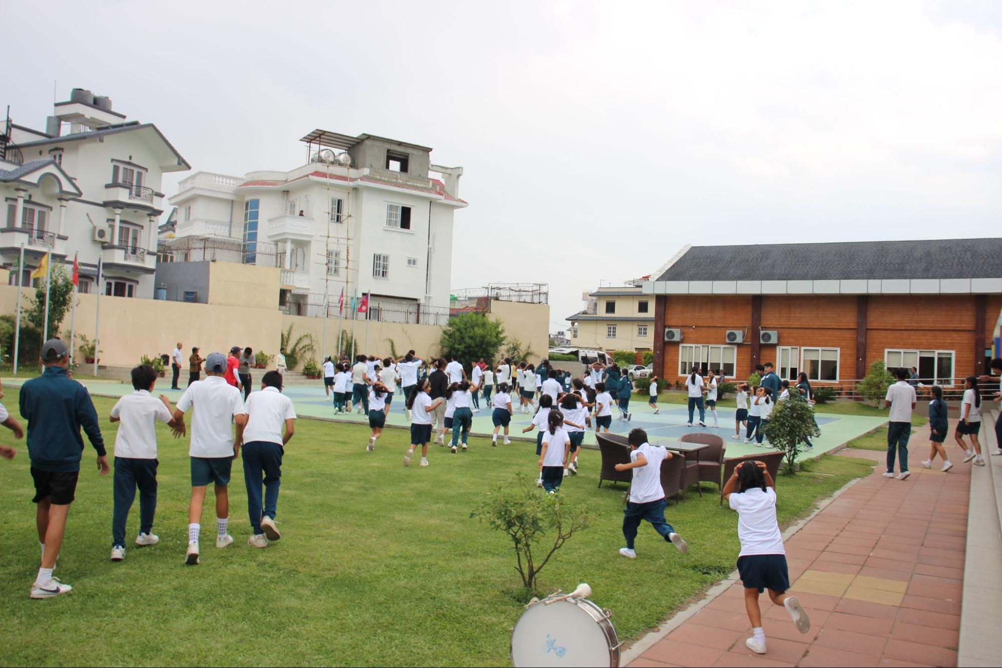 Imperial World School students evacuate to a safe assembly point during an earthquake safety drill and disaster preparedness training.