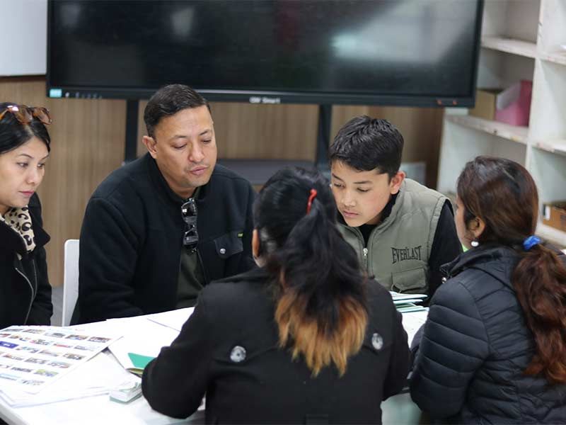 Imperial World School parents and teachers discuss student progress at the Third Quarter PTSC event in Kathmandu, January 8, 2025.