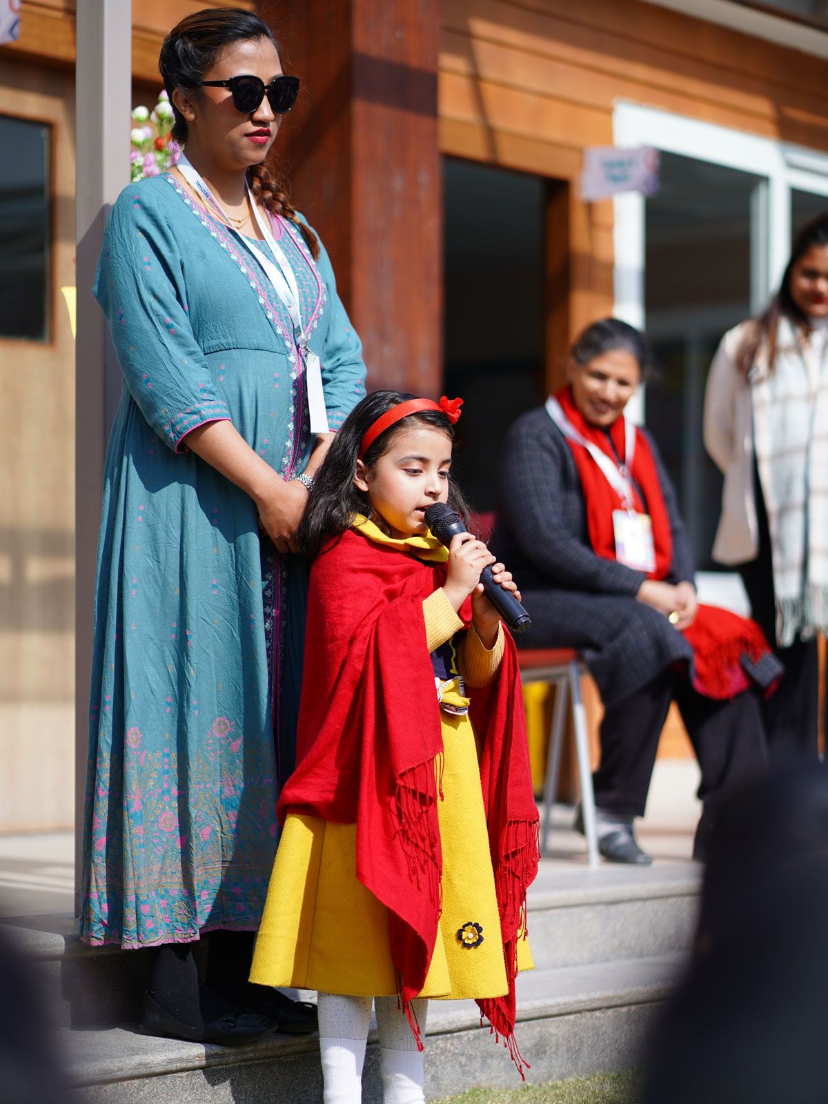 A teacher at Imperial World School with students at an outdoor event, showcasing community engagement.