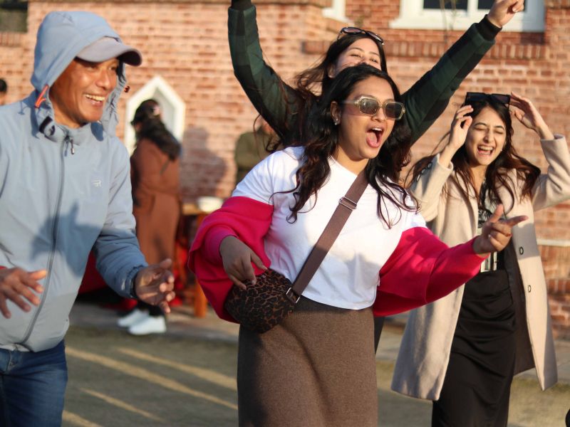 Imperial World School staff celebrating teamwork and success at the 2025 Annual Picnic in Kathmandu, enjoying fun outdoor activities.