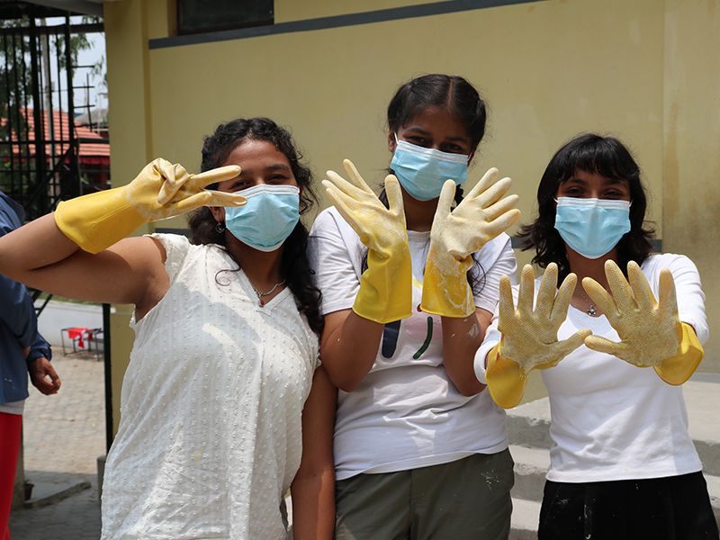 Grade 9 students paint at Madan Ashrit Adarsha Basic School, June 16, 2024, for community service.