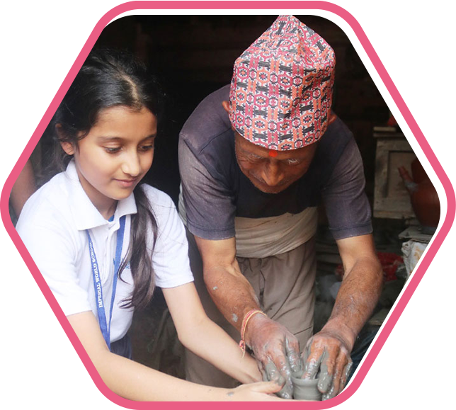 A student at Imperial World School working on pottery with an instructor, participating in a hands-on arts activity.