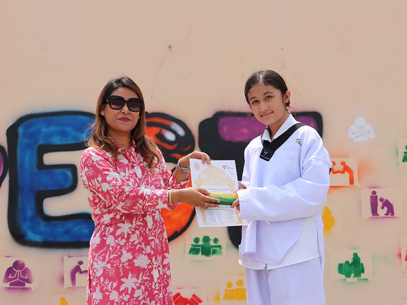 Students at Imperial World School's Taekwondo Belt Upgrade Ceremony, June 19, 2024, proudly advance levels.